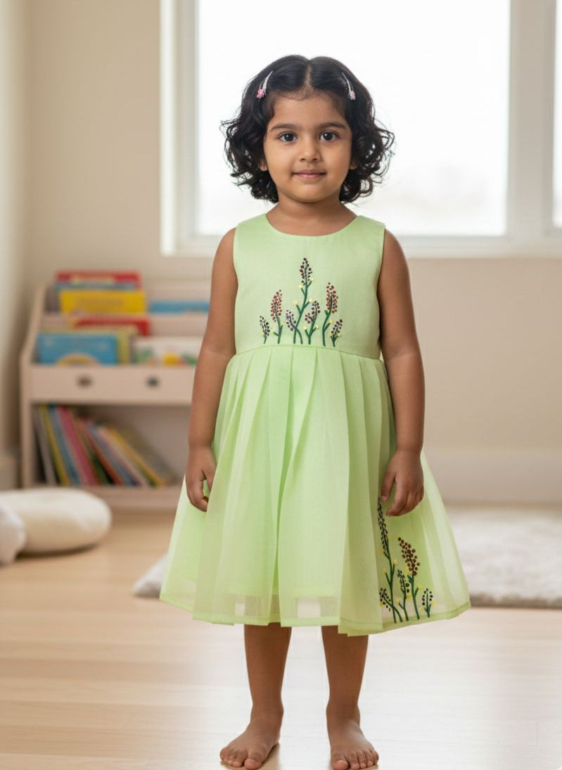 Young girl wearing a light green BABY BLOOM CP074-GREEN HAND PAINTED CHANDERI COTTON FROCK
